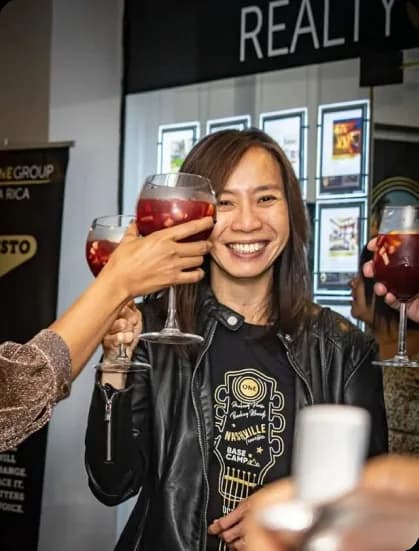 A broker raising a glass at a Realty ONE Group event